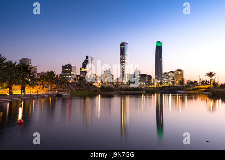 Pond at Bicentennial Park in the wealthy Vitacura district and skyline of buildings at financial district, Santiago de Chile Stock Photo