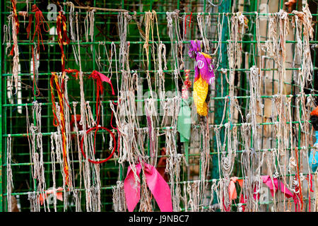 A iron web window of shri galta ji mandir (monkey temple) with lots of tied threads on it , showing faith, belief in god also showing superstition. Stock Photo