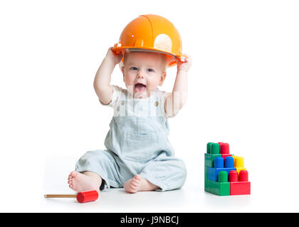 Baby in hardhat playing toys isolated on a white background. Stock Photo