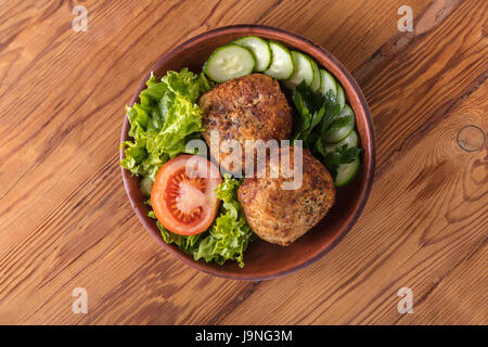 scotch egg with vegetables on a wooden background
