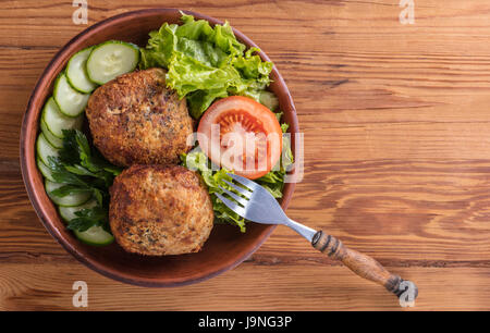 scotch egg with vegetables on a wooden background