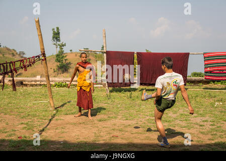 Young men kicking a wicker ball in a small village near Inle Lake, Myanmar. Stock Photo