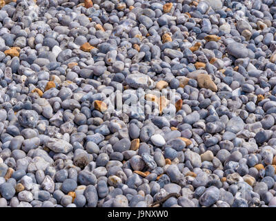 Background of smooth pebbles in different colors and sizes on the beach Stock Photo