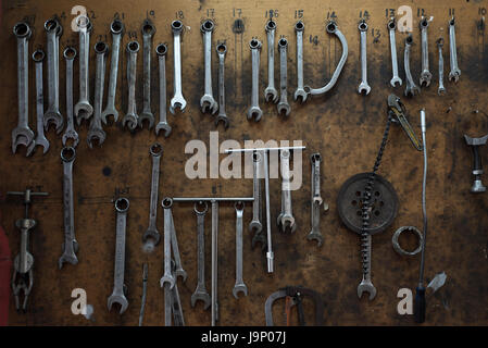 Assorted tools hanging in workshop Stock Photo