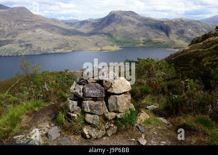 stone markers on the Beinn Eighe Moutain Trail National Nature Reserve towards Loch Maree and Slioch Mountains Scotland UK GB Stock Photo