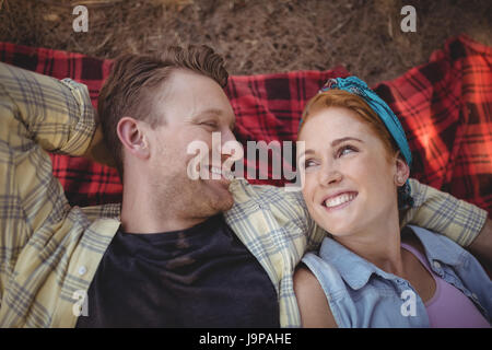 Overhead view of smiling young couple lying on mat at farm Stock Photo