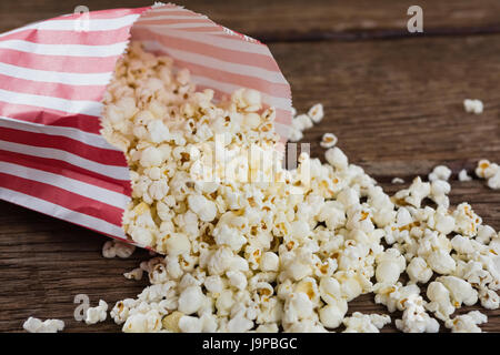 Close-up of spilled popcorn on wooden table with 4th july theme Stock Photo
