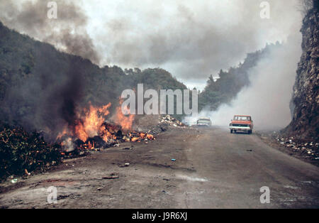 Trash burns openly in a makeshift garbage dump on highway 112 February 1973 near San Sebastian, Puerto Rico. Stock Photo