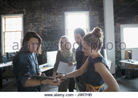 Creative business people with digital tablet meeting in office