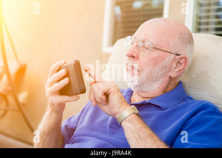 Senior Adult Man Using Smart Cell Phone. Stock Photo