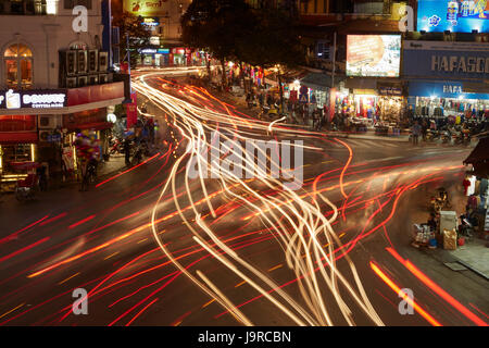 Lights from traffic at busy intersection by Hoan Kiem Lake and Old Quarter, Hanoi, Vietnam Stock Photo