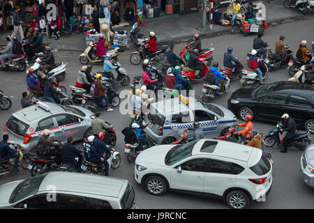 Crazy traffic at busy intersection by Hoan Kiem Lake and Old Quarter, Hanoi, Vietnam Stock Photo