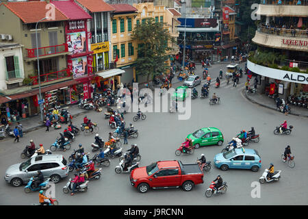 Crazy traffic at busy intersection by Hoan Kiem Lake and Old Quarter, Hanoi, Vietnam Stock Photo