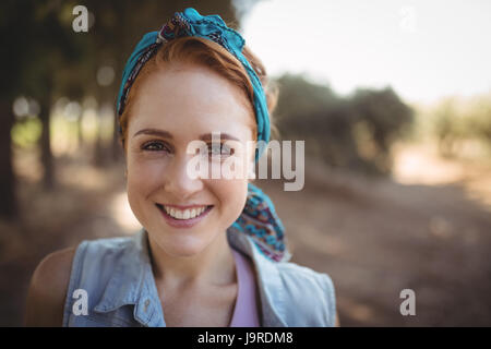 Close up portrait of smiling young woman at olive farm Stock Photo