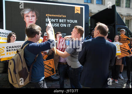 London, UK. 3rd June, 2017. Pro-Brexit activists carrying red placards disrupt the unveiling by Sir Simon Hughes, Liberal Democrat candidate and former Member of Parliament for Southwark and Old Bermondsey, of a Dementia Tax poster featuring an image of Prime Minister Theresa May accompanied by the words ‘Don’t bet your house on her’. Credit: Mark Kerrison/Alamy Live News Stock Photo