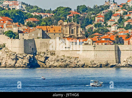 October 5, 2004 - Dubrovnik, Dubrovnik-Neretva County, Croatia - Small boats approach the Old Town of Dubrovnik, encircled with massive medieval stonewalls. On the Adriatic Sea in southern Croatia, it is a UNESCO World Heritage Site and a top tourist destination. (Credit Image: © Arnold Drapkin via ZUMA Wire) Stock Photo