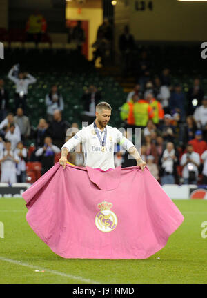 Sergio Ramos the Real Madrid captain plays with a flag on the pitch after his team won The Champions League trophy after the UEFA Champions League Final between Juventus and Real Madrid at National Stadium of Wales in Cardiff tonight. Stock Photo