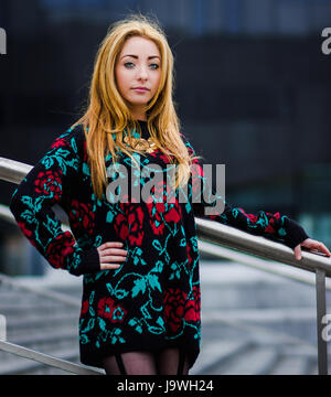 Waist up portrait of Alex outside the modern Mann Island complex along the Liverpool waterfront. Stock Photo