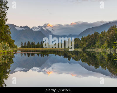 Sunset, Mirror Island, Mt. Tasman and Mt. Cook, Reflection in Lake Matheson, Mount Cook National Park, Westland National Park Stock Photo