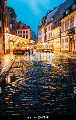 Riga, Latvia - July 3, 2016: Cafe In Lighting At Evening Or Night Illumination In Old Town In Skarnu Street Stock Photo