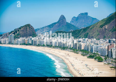 Bright scenic view of the Rio de Janeiro, Brazil skyline overlooking the shore of Copacabana Beach and dramatic mountains in the background Stock Photo
