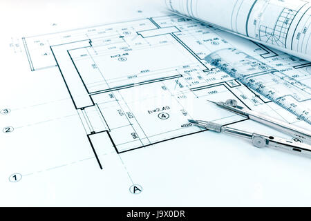 rolled blueprints, ruler and drawing compass on graphical architectural project of apartment Stock Photo