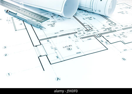 rolls of plans, drawing and measurement tools on architectural project of house Stock Photo