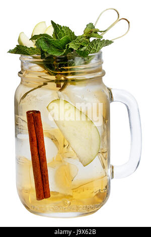 Fresh refreshing drink with ice cubes in Mason jars with apple, cinnamon and mint. Summer drink on white background. isolated. Stock Photo
