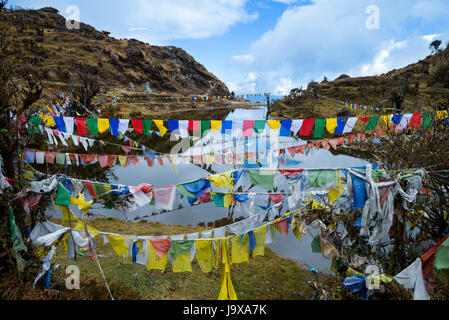 Lungta or prayer flags flung at Kala Pokhri, the Black Water Pond. They are to promote peace, strength, compassion, and wisdom Stock Photo
