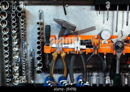 Background image of various mechanic tools on stand in auto-repairing workshop Stock Photo