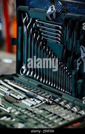 Background closeup shot of opened toolbox with various wrenches in mechanics garage Stock Photo