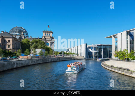 River cruise boat on the Spree River in front of the German parliament buildings, Mitte, Berlin, Germany Stock Photo