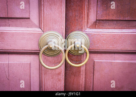 traditional metal open door on a retro wooden door is unlock. Stock Photo
