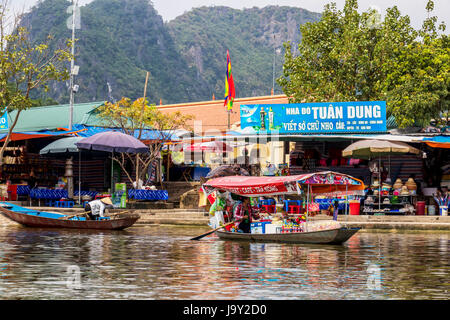 Tourist on Perfume Pagoda trip making their way to famous caves and temples in boats along Yen Vy river in North Vietnam Stock Photo