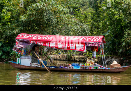 Tourist on Perfume Pagoda trip making their way to famous caves and temples in boats along Yen Vy river in North Vietnam Stock Photo