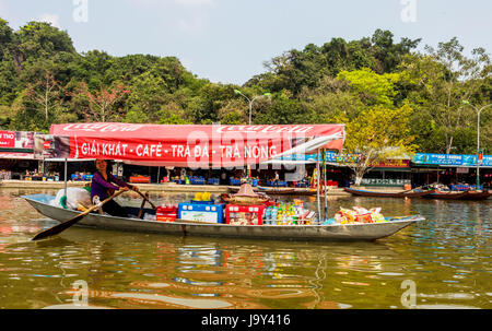 Tourist on Perfume Pagoda trip making their way to famous caves and temples in boats along Yen Vy river in North Vietnam Stock Photo