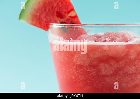 Glass of healthy watermelon juice in summertime on blue background. Stock Photo