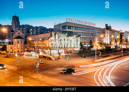 Minsk, Belarus - April 3, 2017: Evening Night Traffic Near Cathedral of Saints Peter and Paul and Bas-relief of the Soviet era on old facade building  Stock Photo