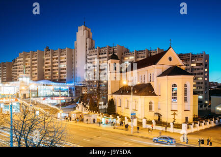 Minsk, Belarus - April 3, 2017: Evening Night View Of Cathedral of the Holy Apostles Sts Peter and Paul On Illuminated Nemiga Street. Temple of the Be Stock Photo