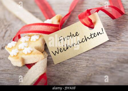a golden label with the german words Frohe Weihnachten which means merry christmas Stock Photo