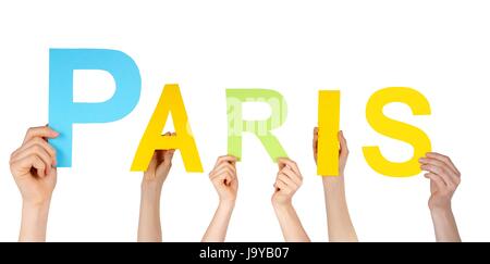 many hands holding the name of the french capital Paris, isolated Stock Photo