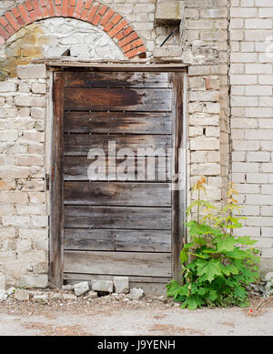 wooden plank door, dirty grunge brick wall Stock Photo