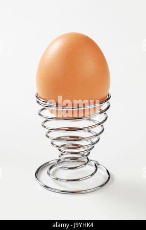 Egg in modern spiral metal egg cup Stock Photo