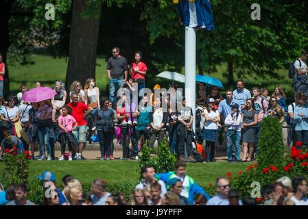 Tourists watch the Major General’s Review rehearsal for Trooping the Colour from Constitution Hill opposite Victoria Memorial in London Stock Photo