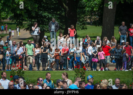 Tourists watch the Major General’s Review rehearsal for Trooping the Colour from Constitution Hill opposite Victoria Memorial in London Stock Photo