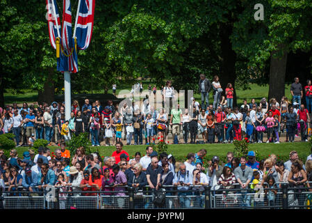 Tourists watch the Major General’s Review rehearsal for Trooping the Colour from Constitution Hill opposite Victoria Memorial in London Stock Photo