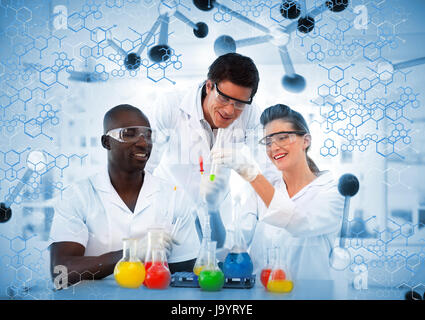 Happy scientist examining test tube in laboratory on digitally generated background Stock Photo