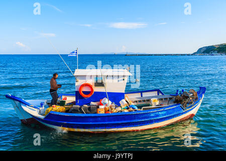 SAMOS ISLAND, GREECE - SEP 24, 2015: local fisherman in his boat sailing on blue sea, Samos island, Greece. Stock Photo