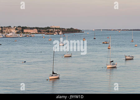 Sailboats moored along the Ashley River with the city skyline at sunset in Charleston, South Carolina. Stock Photo