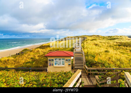 SYLT ISLAND, GERMANY - SEP 11, 2016: Coastal walkway along Wenningstedt beach at sunrise, Sylt island, North Sea, Germany. Stock Photo